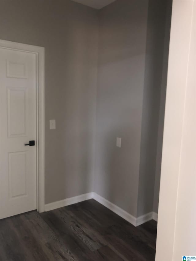 empty room with dark wood-type flooring