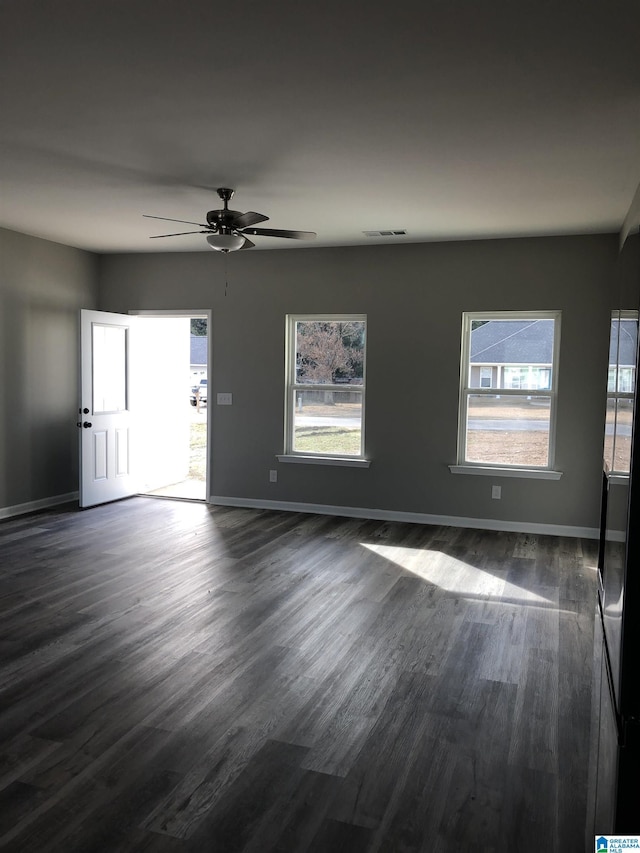 unfurnished room featuring ceiling fan and dark hardwood / wood-style flooring