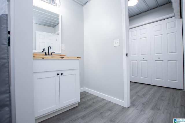 bathroom featuring hardwood / wood-style flooring and vanity