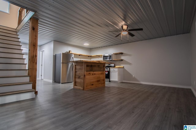 unfurnished living room featuring ceiling fan and dark hardwood / wood-style floors