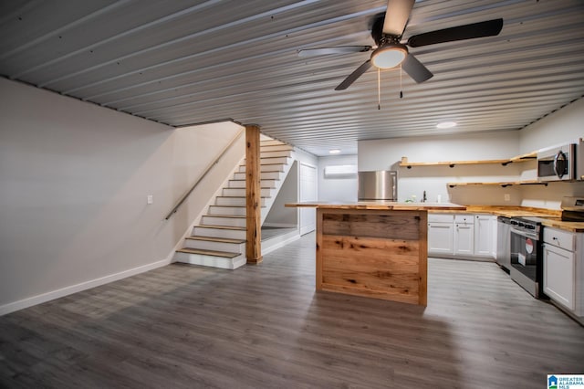 kitchen with butcher block countertops, hardwood / wood-style flooring, stainless steel appliances, and white cabinets