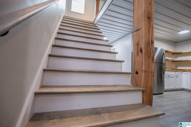 stairs with hardwood / wood-style floors