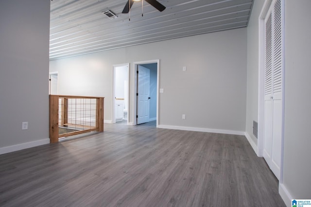 unfurnished room with ceiling fan and dark hardwood / wood-style flooring