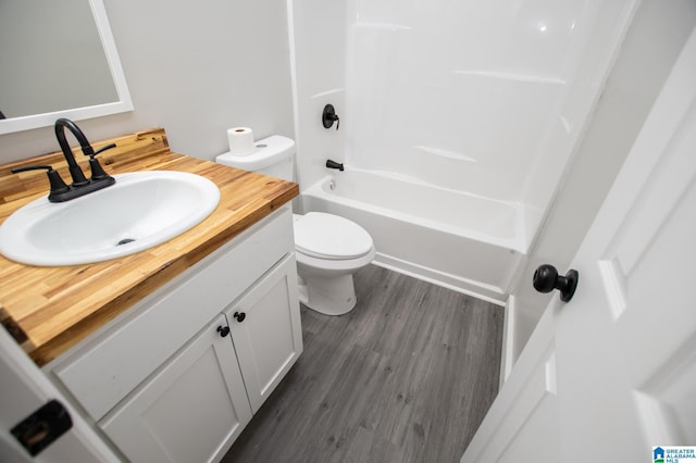 full bathroom featuring shower / tub combination, wood-type flooring, toilet, and vanity