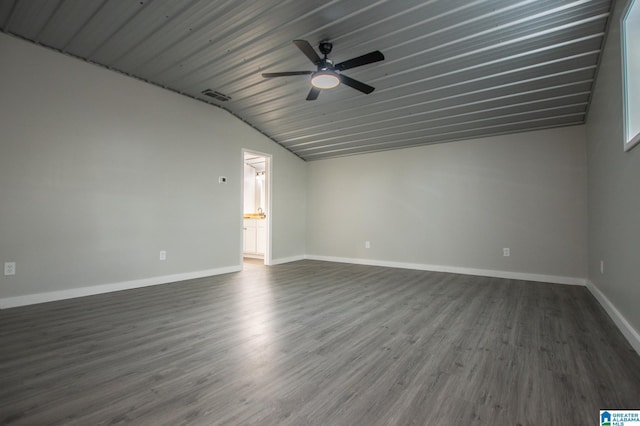 empty room featuring ceiling fan, lofted ceiling, and dark hardwood / wood-style flooring