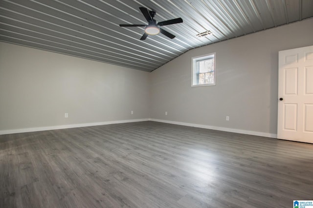 unfurnished room with vaulted ceiling, dark hardwood / wood-style floors, and ceiling fan