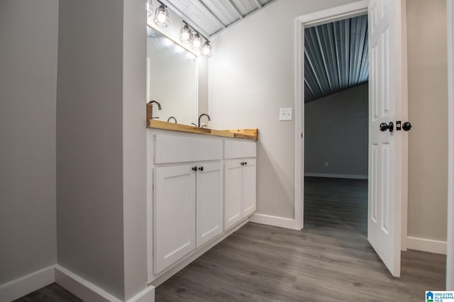 bathroom featuring hardwood / wood-style flooring and vanity