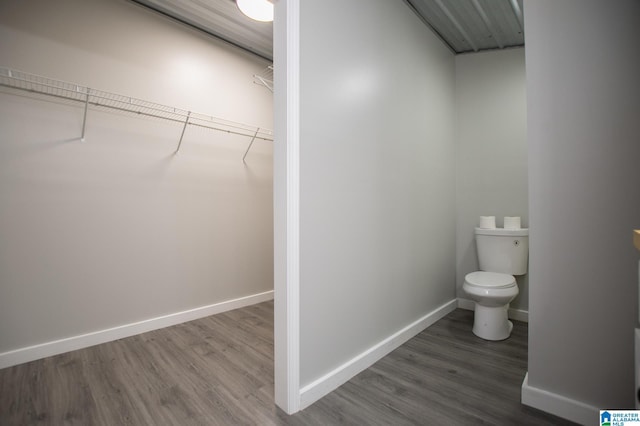 bathroom with hardwood / wood-style flooring and toilet