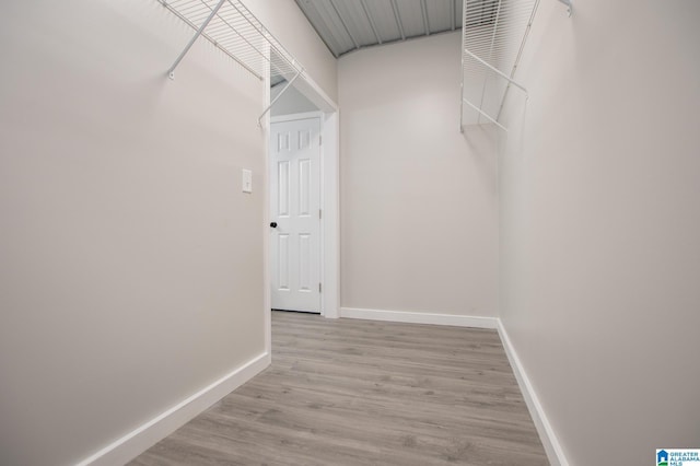 spacious closet with light hardwood / wood-style flooring