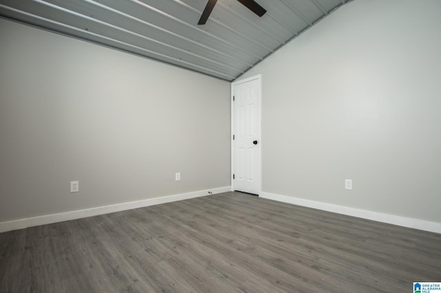 empty room with dark wood-type flooring, ceiling fan, and lofted ceiling