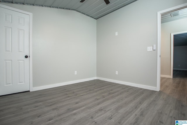 spare room with vaulted ceiling, hardwood / wood-style floors, and ceiling fan