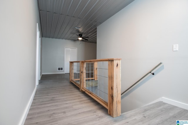 corridor with light hardwood / wood-style flooring