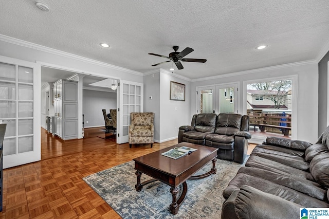 living room with parquet floors, ornamental molding, french doors, and a textured ceiling