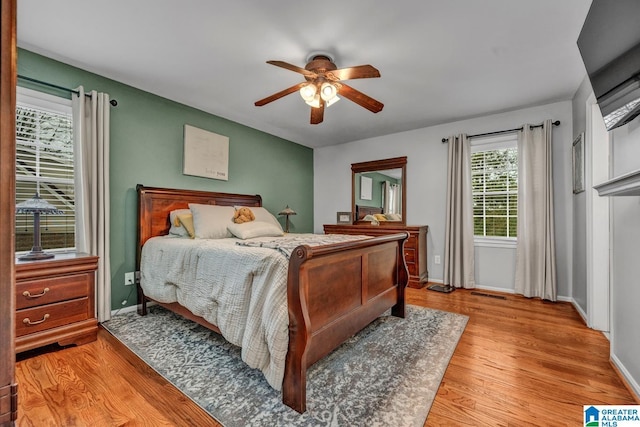 bedroom featuring light hardwood / wood-style flooring and ceiling fan