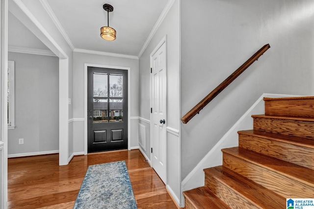 entryway with crown molding and wood-type flooring