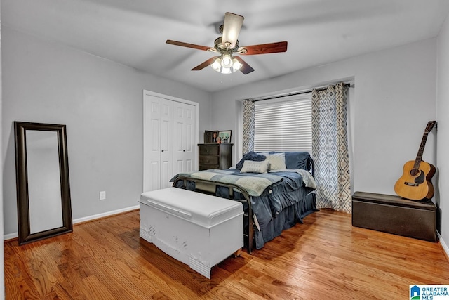 bedroom featuring ceiling fan, wood-type flooring, and a closet