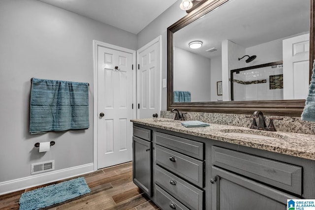 bathroom featuring vanity, wood-type flooring, and walk in shower