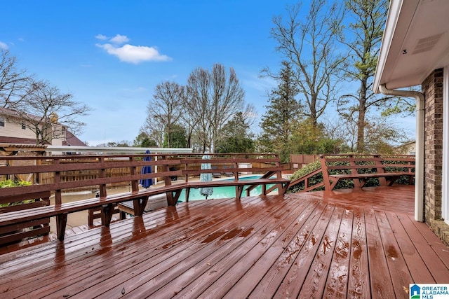 deck with a fenced in pool