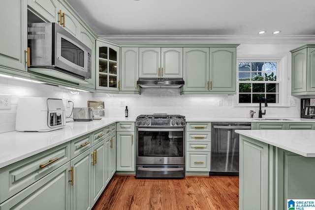 kitchen featuring green cabinetry, stainless steel appliances, and sink