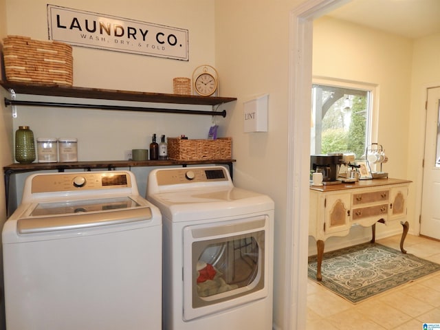 laundry room with light tile patterned floors and washer and clothes dryer