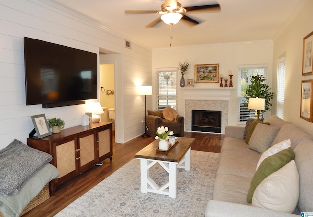 living room with crown molding, ceiling fan, and dark hardwood / wood-style floors