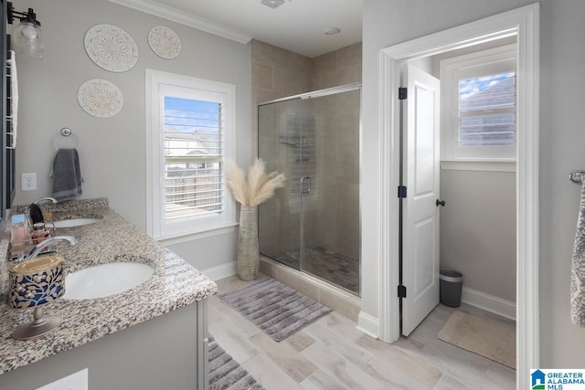 bathroom featuring vanity, ornamental molding, and an enclosed shower