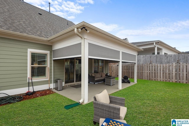 rear view of property with a yard, an outdoor hangout area, and a patio area