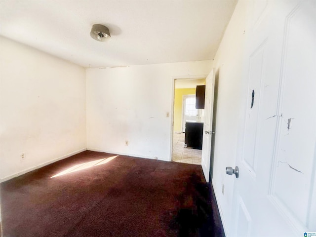 spare room featuring light colored carpet