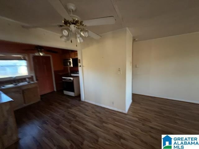 kitchen with baseboards, a ceiling fan, dark wood-type flooring, and range with electric stovetop