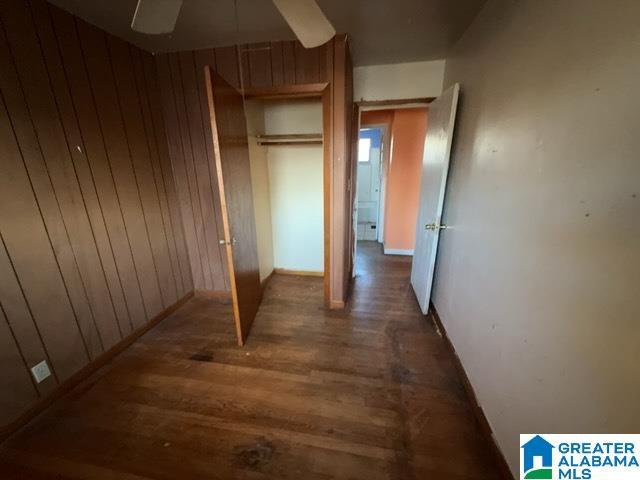 hall featuring wooden walls and wood finished floors