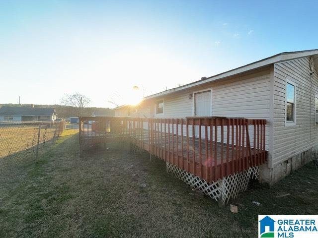 view of yard featuring fence and a deck