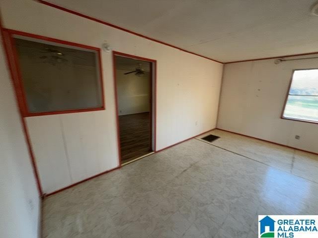 unfurnished bedroom with visible vents, crown molding, and tile patterned floors