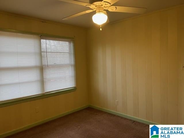 unfurnished room featuring crown molding, carpet flooring, and ceiling fan