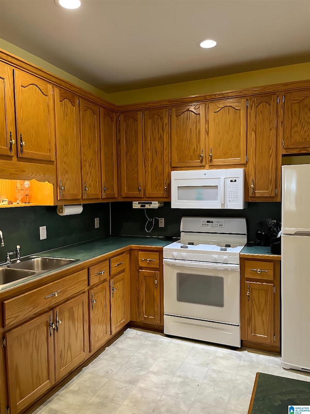 kitchen featuring white appliances and sink