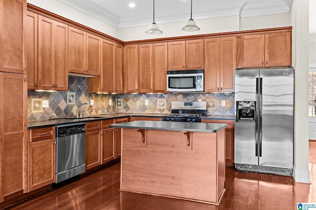 kitchen featuring a sink, stainless steel appliances, crown molding, dark countertops, and brown cabinets