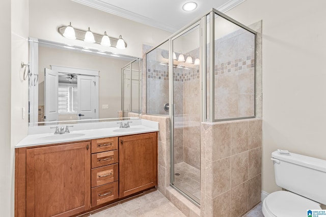 bathroom featuring ornamental molding, toilet, a shower with door, and vanity