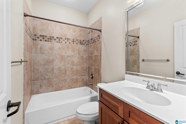 full bathroom featuring tiled shower / bath combo, vanity, and toilet