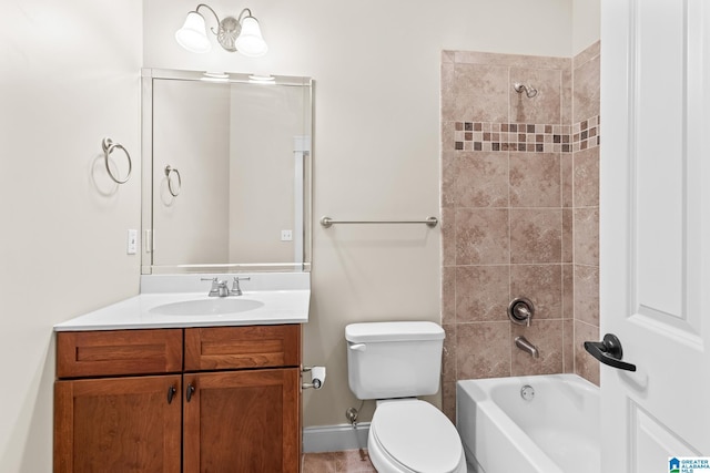 bathroom with shower / washtub combination, toilet, vanity, and baseboards