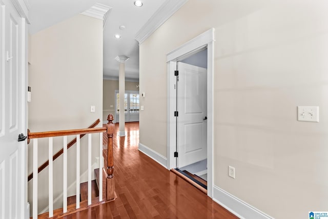 corridor with ornamental molding, an upstairs landing, recessed lighting, wood finished floors, and ornate columns