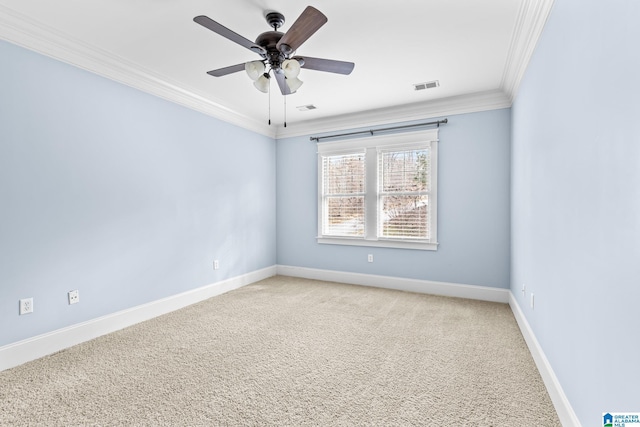 unfurnished room featuring a ceiling fan, visible vents, baseboards, crown molding, and light colored carpet