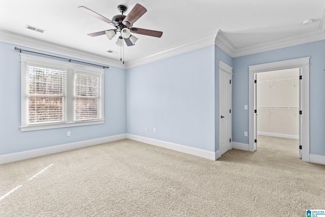 unfurnished room featuring ceiling fan, light colored carpet, and ornamental molding