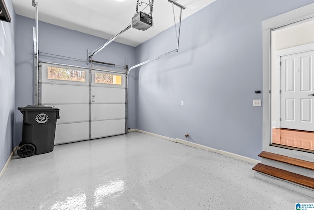 garage featuring a garage door opener and baseboards