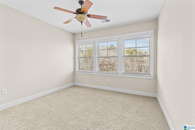 unfurnished room with a healthy amount of sunlight, ceiling fan, and carpet flooring