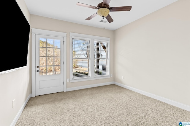 interior space with carpet flooring, ceiling fan, and baseboards