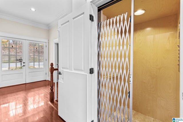 hall with recessed lighting, french doors, wood finished floors, and ornamental molding