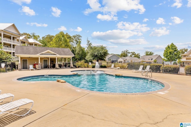 pool featuring a patio area and fence