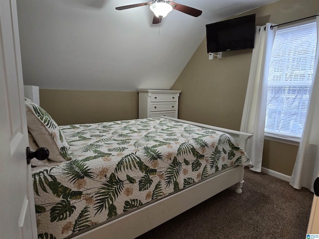 bedroom with vaulted ceiling, ceiling fan, and dark carpet