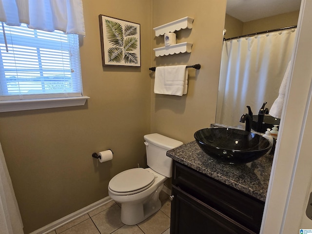 bathroom with tile patterned flooring, vanity, and toilet