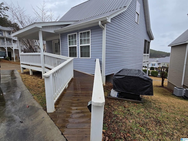 view of side of home with central AC