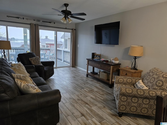 living room featuring ceiling fan and light hardwood / wood-style floors